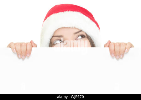 Santa Girl peeking über Schild Stockfoto