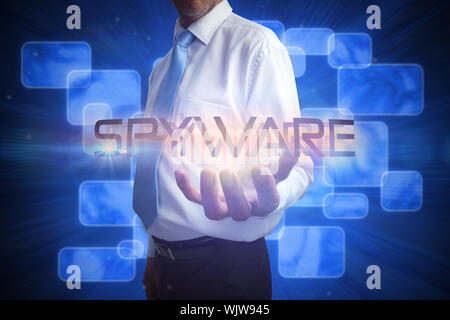 Unternehmer das Wort spyware gegen futuristische blaue Bildschirme Stockfoto