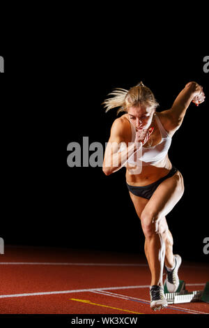 Strong Athletic Girl In A Bright Blue Sport Bra And Black Leggings