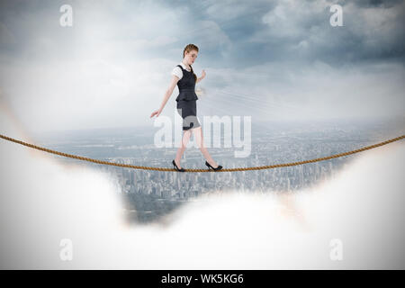 Geschäftsfrau, ein Balanceakt gegen Stadtbild an einer Wand Stockfoto