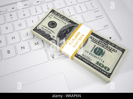 Bündel Dollarscheine liegen auf einer PC-Tastatur. Ansicht von oben Stockfoto