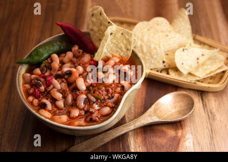 Chili con carne mit black eyed Beans und Nachos. Stockfoto