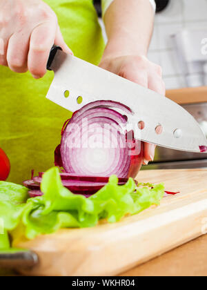 Weibes Hände schneiden Zwiebel Zwiebel, hinter frisches Gemüse. Stockfoto