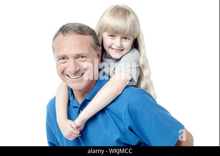 Geben ihrer Tochter eine Huckepack Fahrt Vater Stockfoto