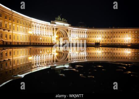 Sankt Petersburg Generalstabsgebäude und Arch beleuchtet und in der Reflexion einer Pfütze auf dem Schlossplatz - abends beleuchtet, Russland Stockfoto