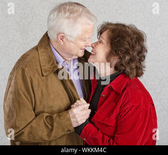 Älterer Mann und Frau küssen einander zu lieben Stockfoto