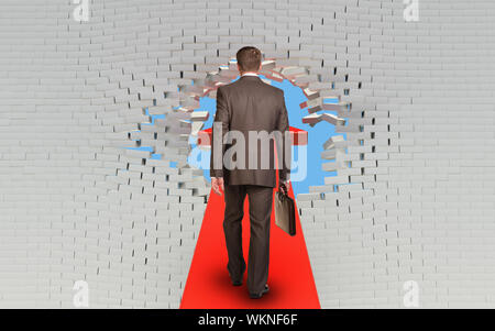 Geschäftsmann mit Aktenkoffer Wandern auf Pfeil durchbohrt brick wall Stockfoto