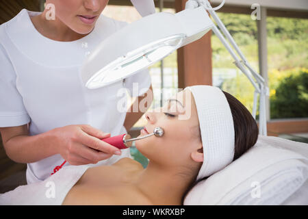 Friedliche brunette getting Micro Dermabrasion von kosmetikerin im Health Spa Stockfoto