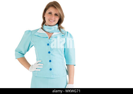 Porträt eines charmanten Stewardess in der blauen Uniform gekleidet auf weißem Hintergrund Stockfoto