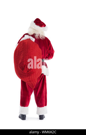 Santa trägt seinen Beutel und auf weißem Hintergrund Stockfoto