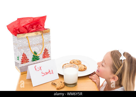 Milch und Kekse für den Weihnachtsmann auf weißem Hintergrund ausgelassen Stockfoto