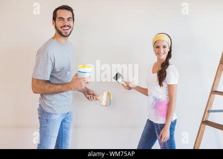 Nettes paar Malerei der Wand in ihrem neuen Zuhause Stockfoto