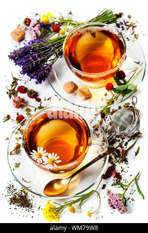 Kräutertee mit Honig, wilde Beeren und Blumen auf hölzernen Hintergrund Stockfoto