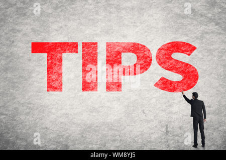 Asian Business Mann schreiben Wörter auf Wand, Tipps Stockfoto