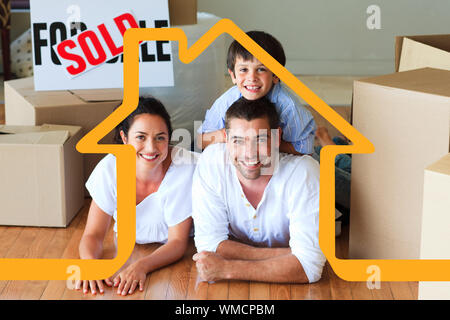 Familie in Ihrem neuen Haus liegen auf dem Boden mit Boxen gegen Haus Umrisse Stockfoto