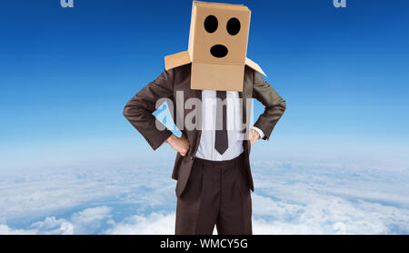 Anonyme Unternehmer mit Händen auf den Hüften gegen den blauen Himmel mit weißen Wolken Stockfoto