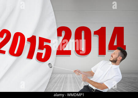 Hipster Geschäftsmann ziehen ein Seil gegen grauen Raum Stockfoto