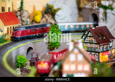 Personenzug mit Diesellok und Schiene Bus auf einer Modellbahnanlage. Stockfoto
