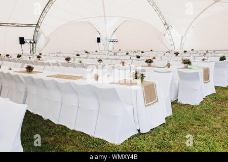 Catering mit weißen langen Tischen und Stühlen. Stockfoto