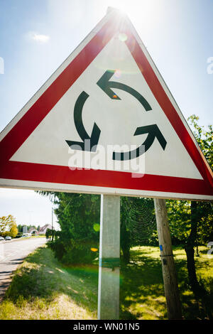 Französische Straße und neue Kreisverkehr Schild darauf hinweist, dass ein Kreisverkehr ist auf der Straße Sonnenlicht flare Stockfoto