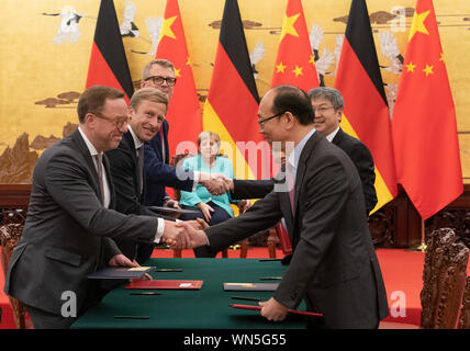 Peking, China. 06 Sep, 2019. Oliver Zipse (2. von links), Vorsitzender des Vorstands der BMW, steht vor Bundeskanzlerin Angela Merkel (CDU) bei der Unterzeichnung von Wirtschaftsabkommen, zusammen mit anderen Vertretern der Branche. Merkel hält auch einen zweitägigen Besuch der Volksrepublik China Credit: Michael Kappeler/dpa/Alamy leben Nachrichten Stockfoto