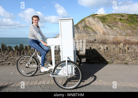 Ilfracombe busker Chloe Aston abgebildet auf ihre einzigartige piano Bike, die sie verwendet, um die Massen zu unterhalten, wenn Sie führt Stockfoto