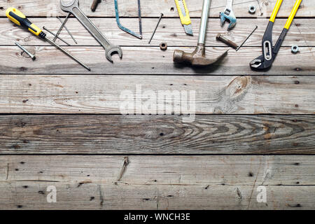 Flach Zusammensetzung mit vintage Zimmerhandwerk-werkzeuge auf rauhen Holz- Hintergrund. Ansicht von oben Workbench mit Tischler verschiedene Werkzeuge. Holzbearbeitung, craftsma Stockfoto