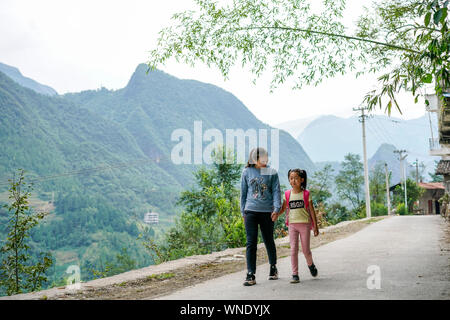 (190906) - chongqing, Sept. 6, 2019 (Xinhua) - ehrenamtliche Lehrer Mu Yi (L) Escorts ein Mädchen zu ihren Eltern nach der Schule bei Luzi Dorf, chengkou County, im Südwesten von China Chongqing Gemeinde, Sept. 3, 2019. Mu Yi, ein 25-jähriger Sportlehrer aus Chongqing Gemeinde, bietet eine Woche-lange freiwillige Lehre service und arbeitet mit einem lokalen Lehrer Tao Yao in diesem abgelegenen Dorf. In der Schule, in der nur zwei zweite - Schüler und 18 Vorschulkinder Studie, Mu Yi und Tao Yao auch andere Jobs als Prinzipale, Reiniger, Köche und repairwomen tun. Mu Yi lehrt Kinder, Sport, Kunst und Musik und t Stockfoto