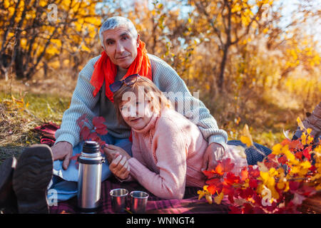Senior paar Tee im Herbst Wald. Glücklich, Mann und Frau, genießen, Picknick und Natur. Zeit mit der Familie Stockfoto