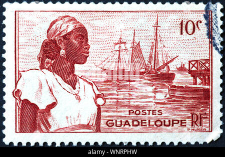 Frau aus Guadeloupe auf vintage Briefmarke Stockfoto