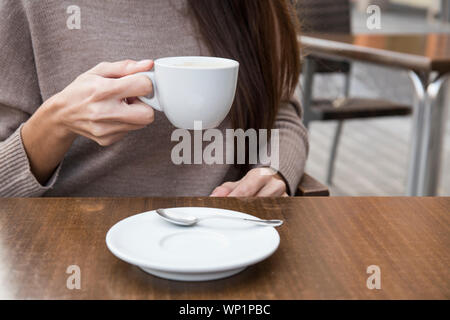 Hände einer Frau mit einer Tasse Kaffee Stockfoto