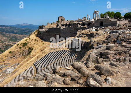 Eine Ansicht, die Ruinen des römischen Theaters (Vordergrund) und das Trajaneum (Tempel) antike Stätte von Pergamon, Bergama in der Türkei. Stockfoto