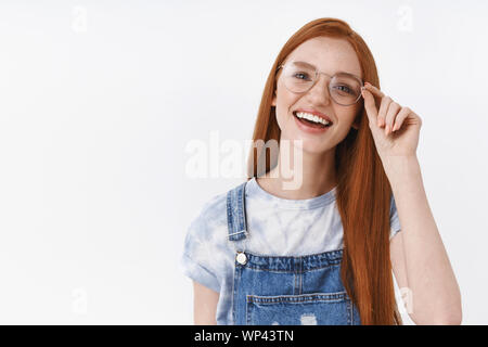 Close-up unbeschwerte Fröhliche rothaarige Mädchen blaue Augen, Lächeln, Lachen, aufrichtigen lebhafte, toothy weiße Grinsen, stand Jeans Overalls t-shirt, Freunde Summe diskutieren Stockfoto