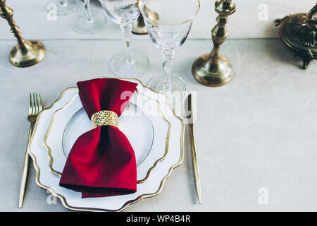 Überblick über ein schön serviert Abendessen mit goldenen Messern und Kerzen. Stockfoto