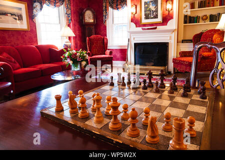 Schachbrett und Stücke in einem eleganten Zimmer. Stockfoto