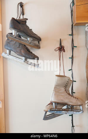 Antike Paar mens und Damen Schlittschuhe an der Wand hängen. Stockfoto