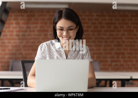 Happy Asian Business woman in Gläsern bei Computer Bildschirm schaut. Stockfoto