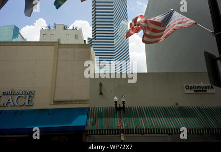 Ansicht der zerrissenen amerikanischen Flagge und Gebäude im historischen Viertel von Downtown Miami, Flagler Street, Miami, Florida, USA Stockfoto