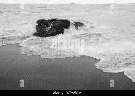 Tide ist in. Teufelskreis Kurven mit der Flut Absturz vor der Küste mit einem sehr starken Rückspülung. Die Brandung ist Schaumig an einem bewölkten Tag. Stockfoto