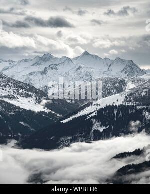 Blick auf die schneebedeckten Alpenhauptkamm mit Großvenediger, hohe Nebel im Tal, Hochbrixen, Brixen im Thale, Brixental, Tirol, Österreich Stockfoto