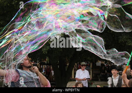 Die Blase Mann unterhalten Kinder einfache bläst Seifenblasen im Bristol Renaissance Faire und Fayre, Mittelaltermarkt, mercats Medievals. Stockfoto