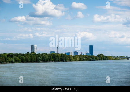 Wien, Österreich - 14 August, 2019: Sommer Landschaft mit Donau und den Wolkenkratzern der Donaustadt bei Sonnenuntergang in Wien Stockfoto