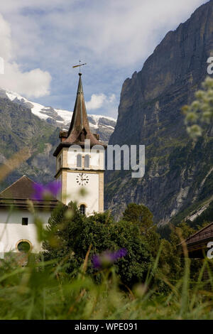 Grindelwald Kirche auf der Dorfstraße mit der Mättenberg und Wetterhorn jenseits, Berner Oberland, Schweiz Stockfoto