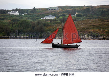 Ein Galway Hooker Segel in flachen Gewässern in der Nähe von Connemara Coast Stockfoto