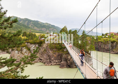 Altai, Russland - 09.08.2019: Blick auf ein Wahrzeichen in der Altairegion Patmos Insel mit einem Kloster, Kirche und Menschen zu Fuß auf einer Hängebrücke Stockfoto