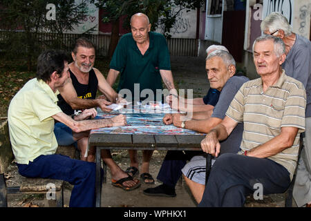 ZRENJANIN, Serbien, SEPTEMBER 05,2019. Eine Gruppe von Senioren meist Rentner Spaß Karten spielen im Freien in den Park. Stockfoto