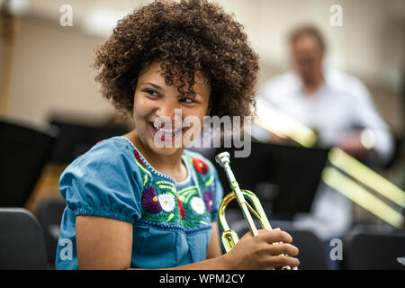 Junges Mädchen lernen, Trompete zu spielen. Stockfoto