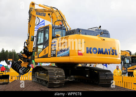 Hyvinkää, Finnland. September 6, 2019. Komatsu HB 215 LC Hybrid Baggerführers zeigt große Präzision durch Entnahme von Pack Karten mit den Ringen. Stockfoto
