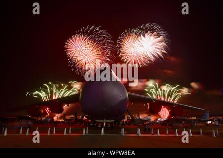 Spektakuläres Feuerwerk hinter massiven Lockheed C-5 M Super Galaxy Flugzeug Boeing Plaza, der EAA AirVenture Oshkosh, Wisconsin, USA geparkt explodieren Stockfoto