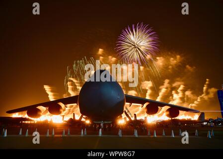 Spektakuläres Feuerwerk hinter massiven Lockheed C-5 M Super Galaxy Flugzeug Boeing Plaza, der EAA AirVenture Oshkosh, Wisconsin, USA geparkt explodieren Stockfoto